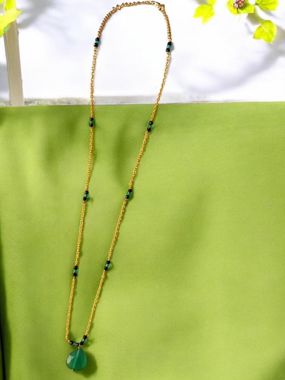 Gold polish chain and green stone  pendant  black  beads