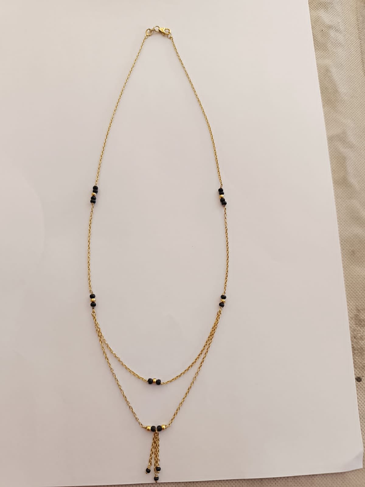 Gold polish chain with black beads and gold small Ball's
