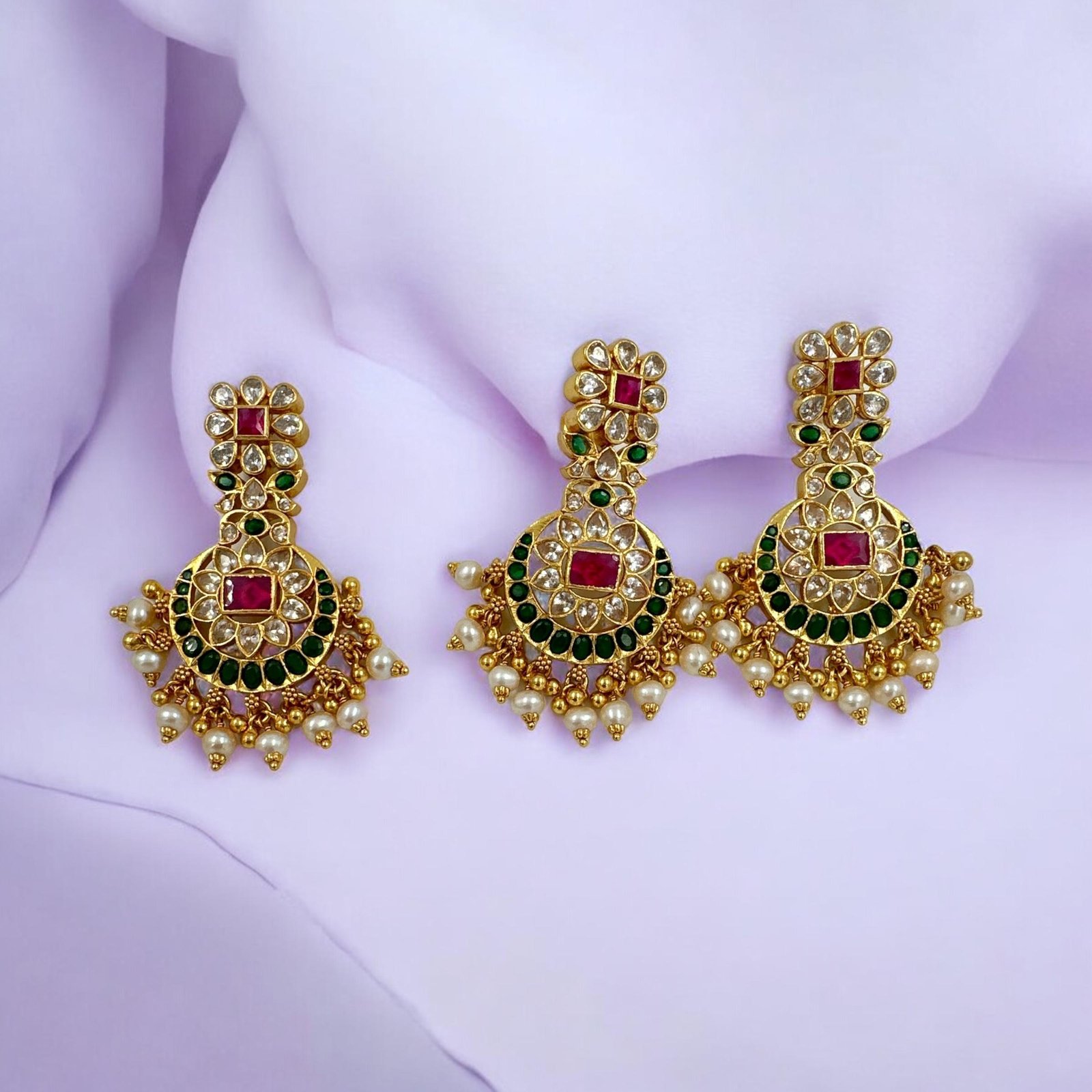 Kundan  stones with gold polish and red and white and green stones with pendent set