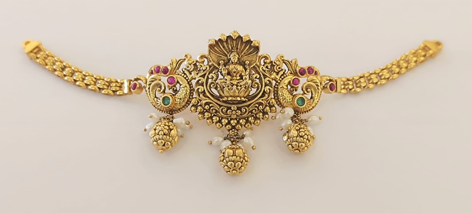 Lakshmi design and peacock design red and green stones with gold polish choker